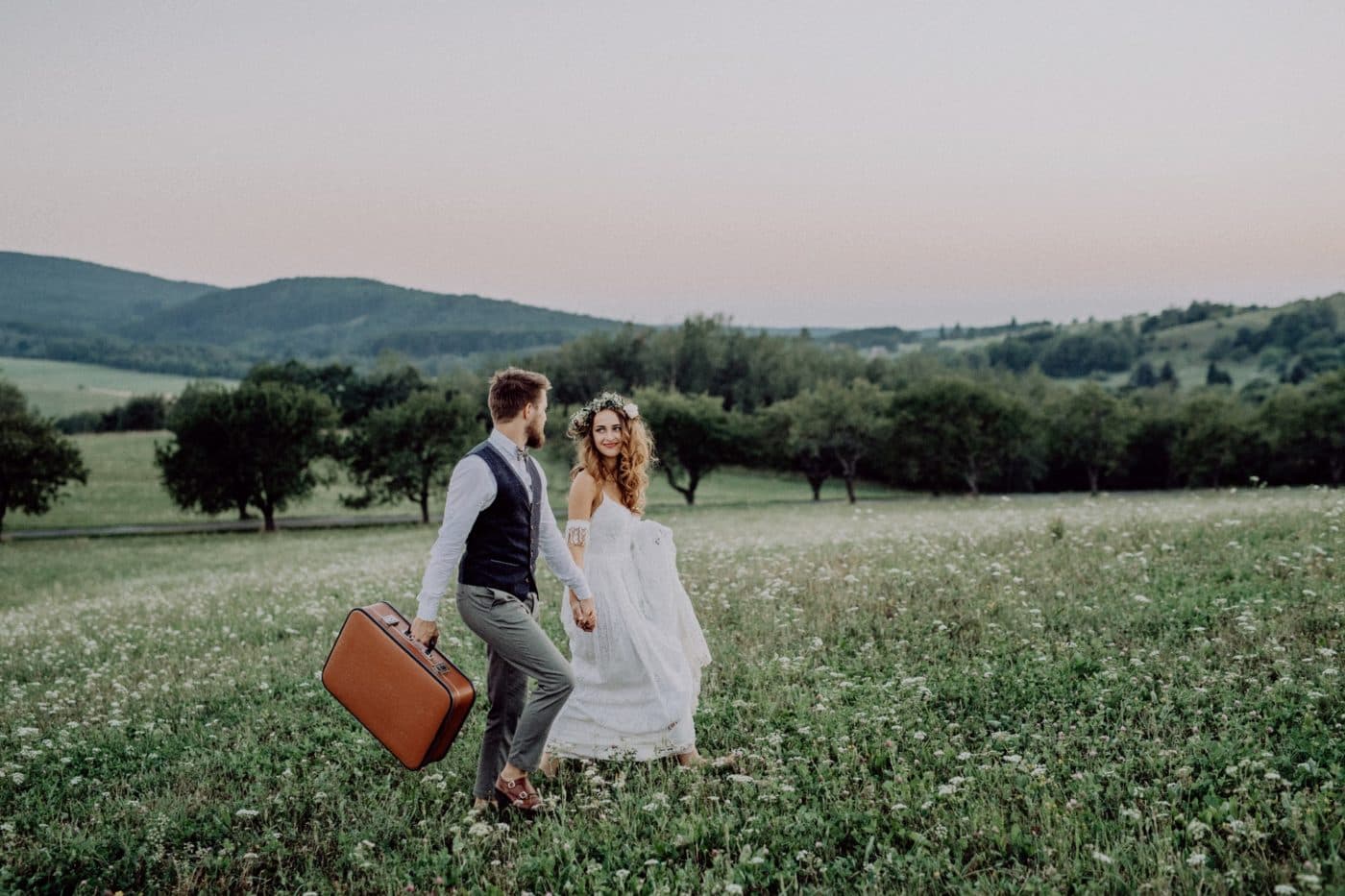 Romantic young bride and groom in green nature